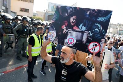 A man holds a picture during a protest calling on the government to end hunger in Gaza, in Sakhnin, Israel July 25, 2025. Reuters