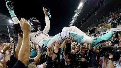Nico Rosberg goes crowd surfing after winning the Formula One drivers' championship. Lars Baron / Getty Images