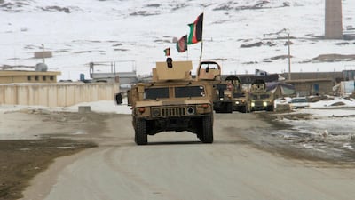 Afghan National Army forces go towards the site of an airplane crash in Deh Yak district of Ghazni province. Reuters