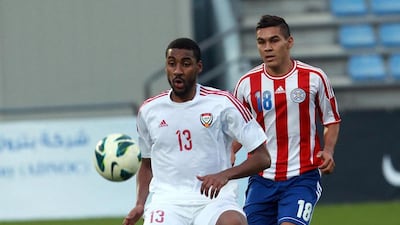 UAE midfielder Khamis Ismail, left, plays keep away with Paraguay midfielder Jorge Rojas in their friendly at Villach, Austria, on September 7, 2014. DANIEL RAUNIG / AFP
