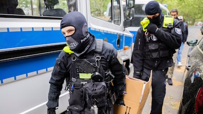 Police remove items during a raid in Berlin related to an investigation into the Last Generation climate activist group. AP