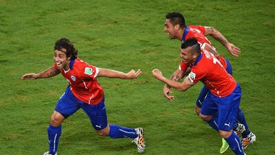 Jorge Valdivia of Chile, left, celebrates scoring the teams second goal with Arturo Vidal, centre, and Gary Medel during the 2014 FIFA World Cup Brazil Group B match between Chile and Australia at Arena Pantanal on June 13, 2014 in Cuiaba, Brazil. Stu Forster/Getty Images