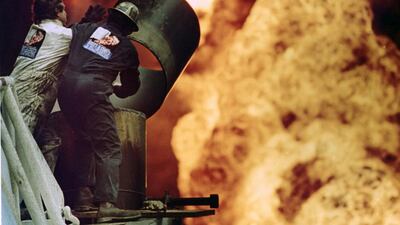 Firefighters from Boots & Coots try to extinguish an oil well fire in Al Ahmadi, Kuwait, in March 1991, after Saddam Hussein’s retreating forces set the wells ablaze in retaliation for their defeat. Russell Boyce / Reuters