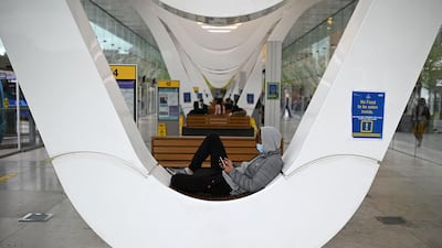 A man wearing a face covering waits for a bus in Blackburn. AFP