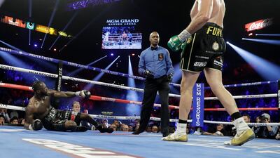 Tyson Fury knocks down Deontay Wilder.