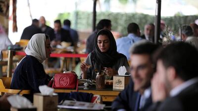 Saudi men and women sit at cafe in Riyadh. Reuters