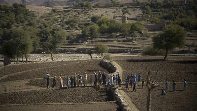 Afghan villagers take a break after preparing the soil for their poppy seeds in fields in Cham Kalai village in Afghanistan’s eastern Nangarhar province, an area which is largely controlled by Taliban. Anja Niedringhaus / AP Photo