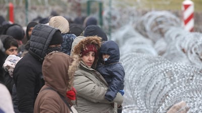 Asylum seekers, refugees and migrants from the Middle East, who left a camp near the border arrive at the Belarusian-Polish checkpoint of Bruzgi-Kuznica. EPA