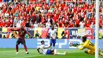 France's Mike Maignan saves a shot from Belgium's Romelu Lukaku. Reuters