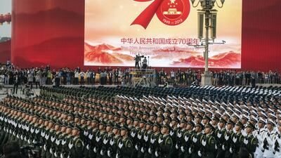 Chinese soldiers march in formation in Tiananmen Square. Getty