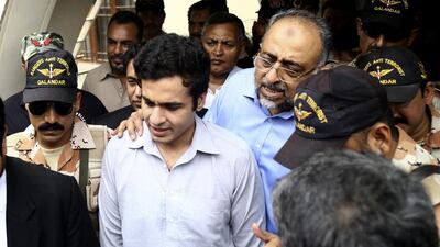 Sajjad Ali Shah with his now-released son Owais. Rehan Khan / EPA