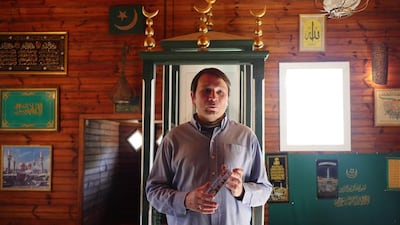 Jamil Gembicki, a Tatar himself, teaches visitors to the mosque about the building and Tatar history. Courtesy Wojciech Oksztol