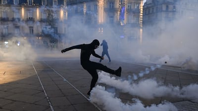 A protestor kicks back a smoking teargas shell during nationwide demonstrations, in Montpellier, southern France on October 31. AFP