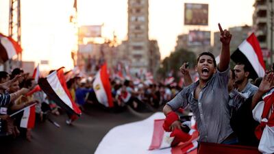 Opponents of Egypt's Islamist President Mohammed Morsi protest outside the presidential palace, in Cairo, Egypt. Hassan Ammar / AP Photo