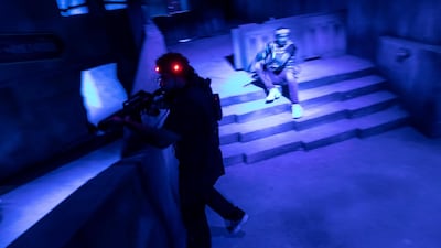 In the dark, the only way to discern what team a player is on, is by their vest - camouflage or plain black. Photo: Antonie Robertson / The National