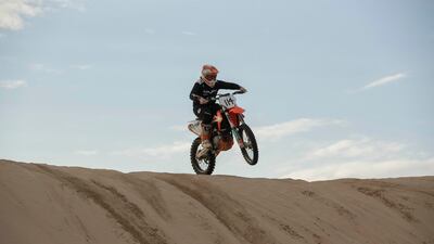Elisha Dessurne crests a sand dune