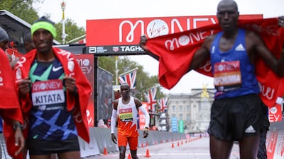 Kenya's Eliud Kipchoge, centre, looks down after crossing the line in eighth place and behind Ethiopia's Shura Kitata, left, who won the London Marathon. AP