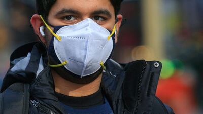 A man wears a double mask as he visits Times Square in New York. AFP