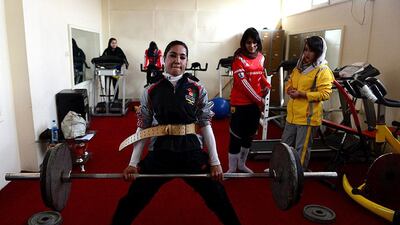 Lida Saeedi is watched by other team members in the gym.