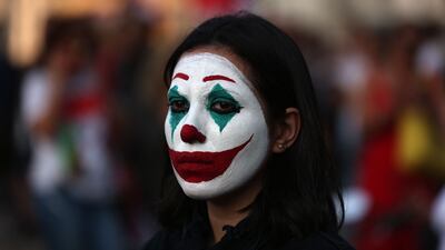 A Lebanese protester, her face painted as DC comic book and film character 'The Joker', in Beirut's downtown district's Martyr's Square, on October 19, 2019. Two years after a now-defunct protest movement shook Lebanon, opposition activists are hoping parliamentary polls will challenge the ruling elite's stranglehold on the country. AFP