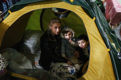 A migrant family on the Belarusian side of the freezing border with Poland. AP