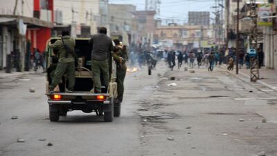 Kurdish security forces riding in a vehicle as they chase down demonstrators in a street in the city of Raniya, 130 kilometres north of Sulaimaniyah, as protests against political corruption raged for a third day despite a clampdown by security forces after five people were killed. Shwan Mohammed / AFP