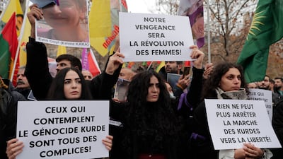 Kurdish activists protest in Paris on Saturday over the shooting at a community cultural centre. AP