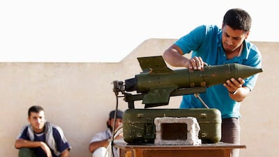 Libyan rebels prepare to fire a wire-guided missile at a position belonging to forces loyal to Libyan leader Muammar Gaddafi, at the front line near the town of Zlitan, west of the rebel-controlled city of Misrata in this August 6, 2011 file photo. When Muammar Gaddafi's government shut off the cellphone network in Misrata in the early days of Libya's uprising, it wanted to stop rebel forces communicating with each other. But the power of a modern phone goes beyond its network. Both rebels and government soldiers have used their phones to take pictures and videos of the conflict, a digital record of fighting from both sides. With the rebels now in Tripoli, the capital, and Gaddafi's whereabouts unknown, those gigabytes of potential evidence may play a role in any war crimes cases. Picture taken August 6, 2011. To match Special Report LIBYA-MISRATA/ REUTERS/Darren Whiteside/Files (LIBYA - Tags: CIVIL UNREST POLITICS SCI TECH BUSINESS) *** Local Caption *** DTW05_LIBYA-MISRATA_0823_11.JPG