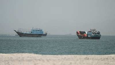 Ships at the Strait of Hormuz, seen from Musandam in Oman. Oil prices are falling as more vessels cross the vital waterway. Reuters