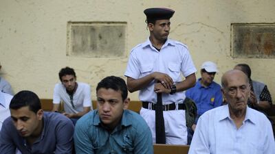 A police officer stands guard near Egyptians waiting for a polling station to open during the Egyptian presidential election in Cairo May 26, 2014. Amr Abdallah Dalsh/Reuters