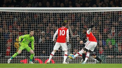 Arsenal's Nicolas Pepe scores the first goal against Manchester United. Reuters