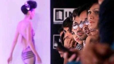 Spectators watch models display creations by designer Khushali Kumar during Lakme Fashion Week in Mumbai on Friday. AP Photo
