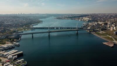 The empty shore side of the Golden Horn, with the Metro bridge in the foreground and Unkapani bridge in the background, in Istanbul. AFP