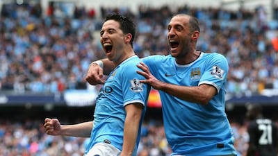 Samir Nasri of Manchester City celebrates scoring the first goal with teammate Pablo Zabaleta on Sunday. Alex Livesey / Getty Images