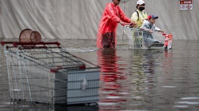Residents are finding innovative ways to plough through the flooded streets. AFP