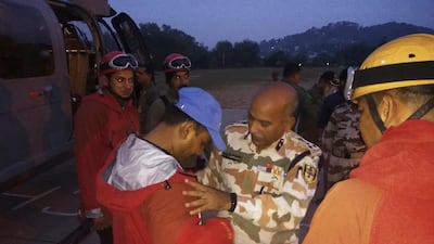A Indo-Tibetan Border Police senior officer wishes luck to the team of soldiers before they leave to rescue and retrieve the bodies of international climbers. AP
