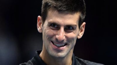 Serbia's Novak Djokovic celebrates after stopping Tomas Berdych at the ATP World Tour Finals tennis tournament in London on November 14, 2014. Djokovic won 6-2, 6-2. The win ensures Djokovic will remain men's world No 1 to the end of the year. Glyn Kirk / AFP