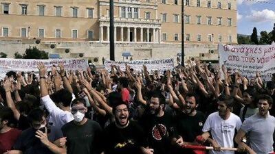Students and teachers protest in front of the Greek parliament yesterday as the country was swept by strikes amid new budget cuts. LOUISA GOULIAMAKI / AFP PHOTO