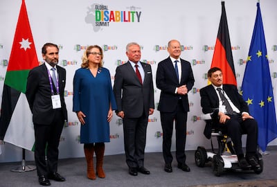 Jordan's King Abdullah, centre, with departing German Chancellor Olaf Scholz, second right, and Nawaf Kabbara, right, of the International Disability Alliance, at the summit in Berlin. Reuters