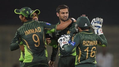 Pakistani spinner Shoaib Malik celebrates with teammates after taking the wicket of Zimbabwe's Hamilton Masakadza during the second T20 international match on Sunday. Aamir Qureshi / AFP / May 24, 2015