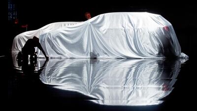 A covered Infiniti being readied for at opening day of the Frankfurt International Motor Show. Boris Roessler / EPA