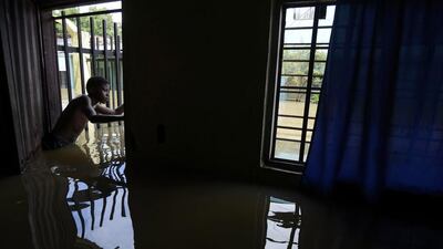 A boy looks on from a building affected by flood water due to the overflowing of the Cauca River, in Cali, Cauca Valley, Colombia. Authorities issued a red alert as eight municipalities of the region have been affected by flooding. Ernesto Guzman Jr / EPA