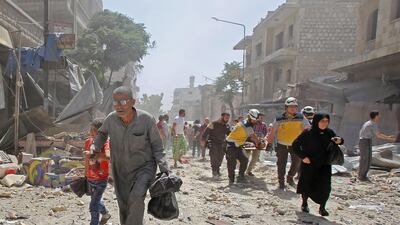 Members of the Syrian Civil Defence (known as the White Helmets) carry a wounded man on a stretcher following a reported air strike on the town of Maaret Al Numan in the militant-held Idlib province on June 3, 2019. AFP