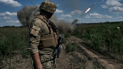 A Ukrainian soldier watches a Grad multiple rocket launcher firing near Bakhmut in Donetsk region. AP