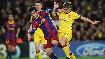 Lionel Messi, left, takes on Andrey Arshavin during Barcelona's 3-1 win at Camp Nou.