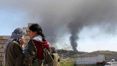 A Kurdistan Workers Party (PKK) fighter looks towards a position hit by ISIL car bombs in Sinjar, Iraq. Asmaa Waquih/ Reuters