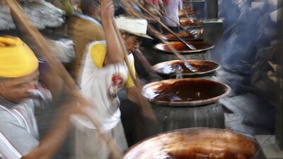 Workers in Tangerang, Jakarta, make a toffee-like sweet cake called “dodol,” one of the traditional delicacies served during Chinese New Year celebrations in Indonesia. Tatan Syuflana / AP Photo