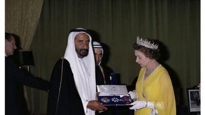 Sheikh Rashid bin Saeed is appointed a Knight Grand Cross of the Order of Saint Michael and Saint George by Queen Elizabeth in Abu Dhabi in February 1979 during her tour of the Gulf States.