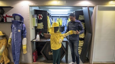 Guests are first fitted with protective beekeeping suits and face shields