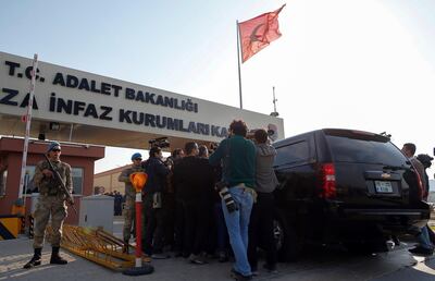 Reporters surround a car believed to be carrying US pastor Andrew Brunson as it arrives at the courthouse for his trial in Izmir. AP Photo